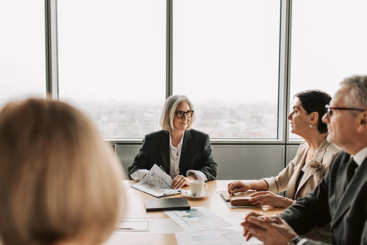 Crafting Captivating Headlines: Your awesome post title goes here A group of professionals engaged in a business meeting inside a modern office boardroom.